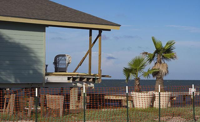 A lone chair sits on the partially rebuilt deck of a Key Allegro home in Rockport.